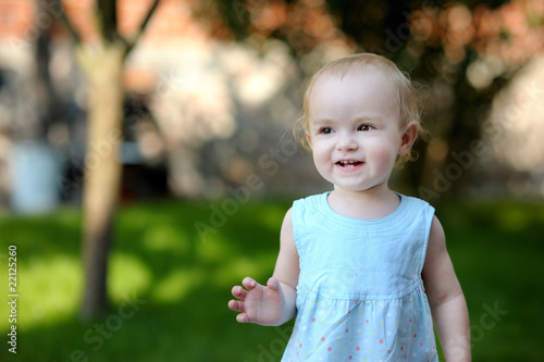 Adorable toddler girl in blue dress