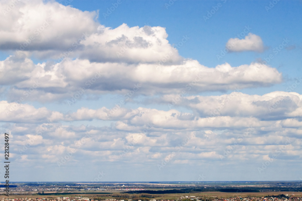 Beatiful white clouds on the blue sky above the horizon