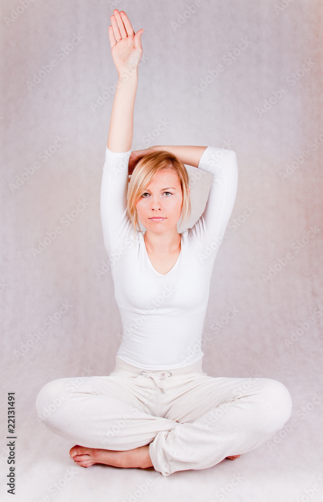 young woman stretching - on white background - obrazy, fototapety, plakaty 