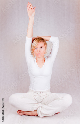 young woman stretching - on white background