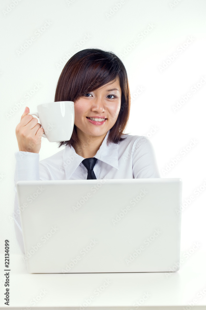 Businesswoman having a cup of coffee at workstation Businesswoman having a cup of coffee at workstation