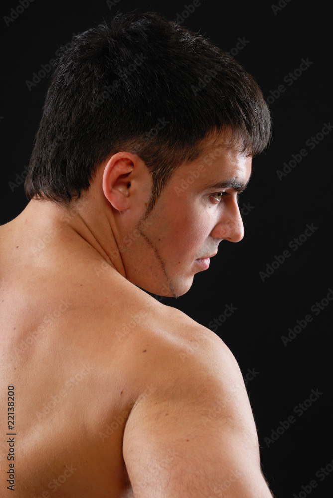 a handsome young man posing on a black background a handsome young man posing on a black background