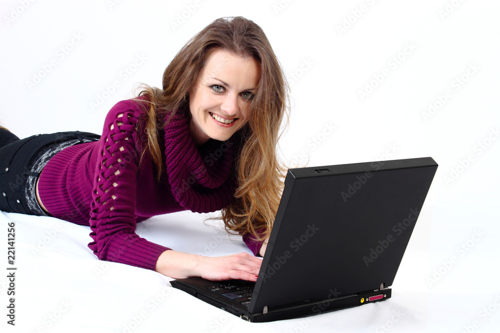 lying and smiling attractive woman with a laptop lying and smiling attractive woman with a laptop