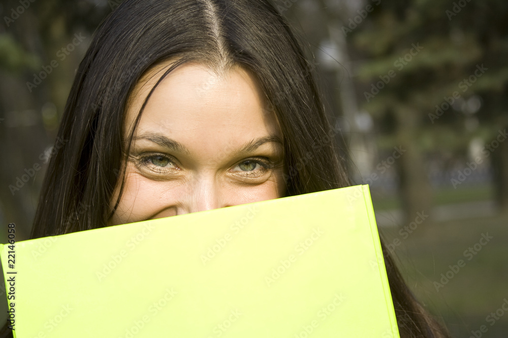 Female hiding behind a folder Female hiding behind a folder