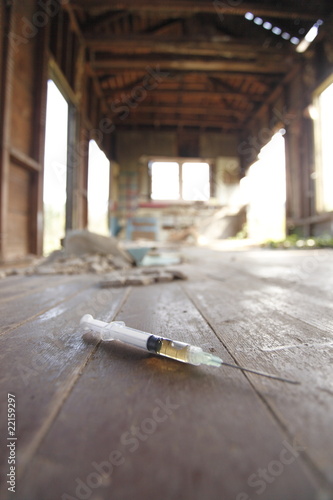 Syringe on the floor of an abandoned house.