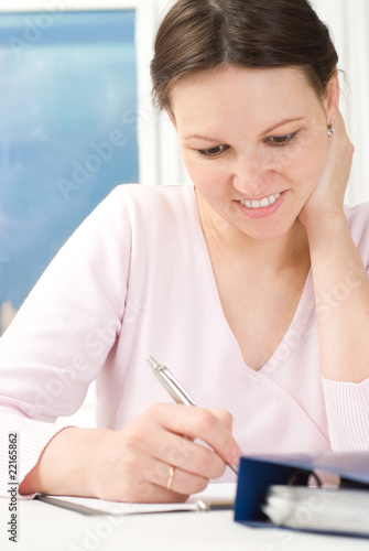 woman sitting at a table and wrote