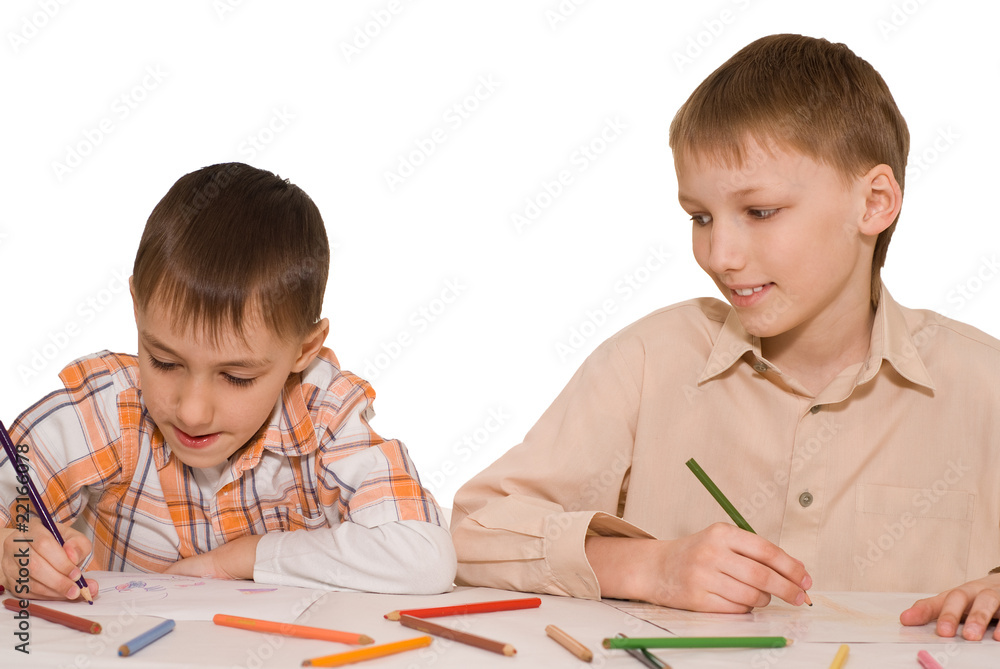 brothers sit at the table and draw brothers sit at the table and draw