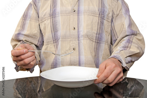 Human hands with fork and white plate