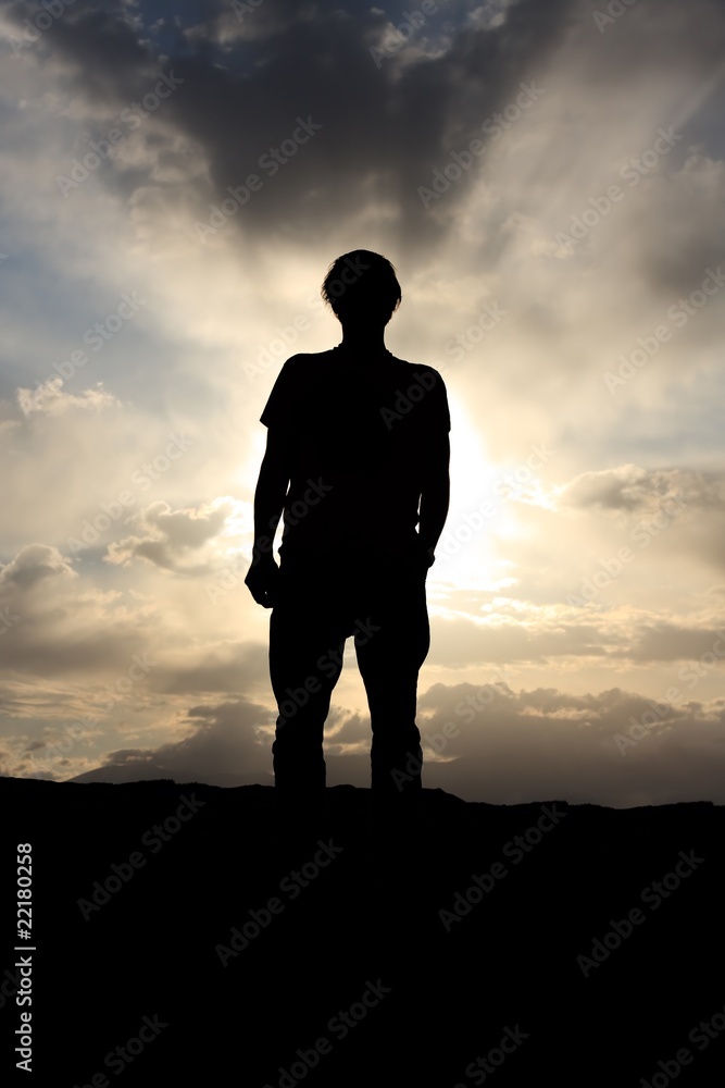 Back lit man before dramatic cloudy sky Back lit man before dramatic cloudy sky