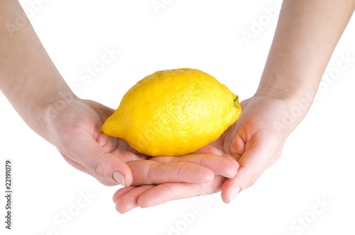 Big lemon in hands isolated on white