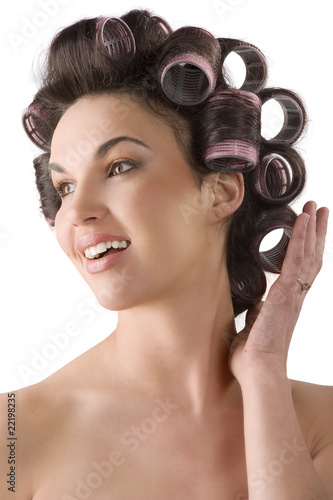 woman smiling with hair rollers