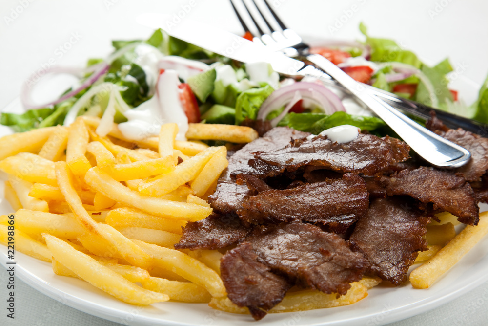 Grilled meat with fried potatoes and vegetables Grilled meat with fried potatoes and vegetables