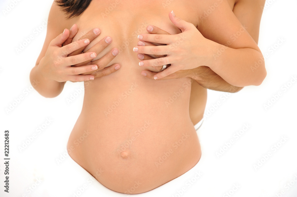 Man and woman holding hands over pregnant woman's breasts Man and woman holding hands over pregnant woman's breasts