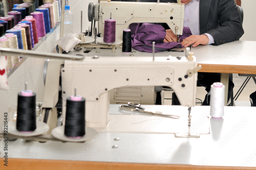 Tailor using industrial sewing machine.