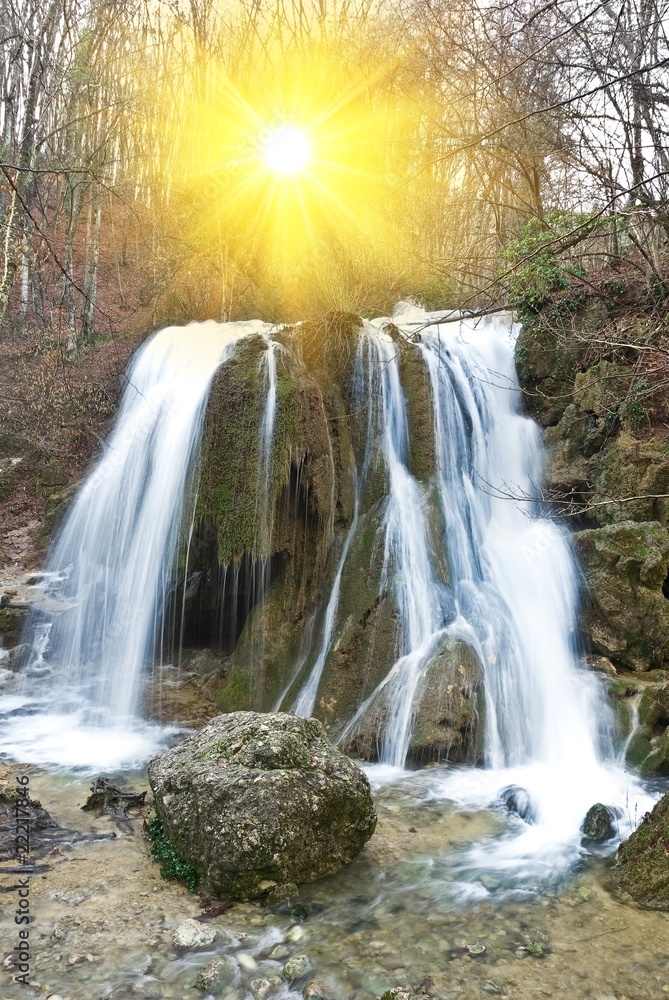 waterfall under a sparkle sun