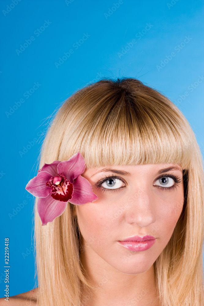 Naklejka premium Portrait of very beautiful woman with orchid in her hair