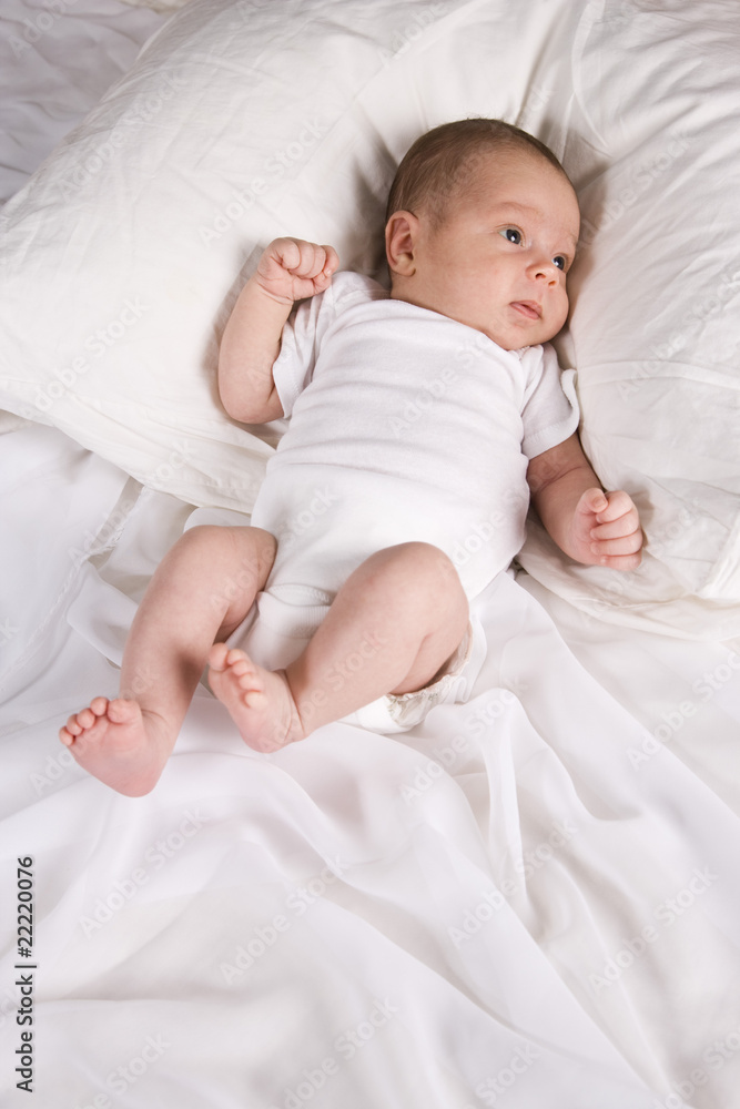 One month old newborn baby boy lying on pillow One month old newborn baby boy lying on pillow