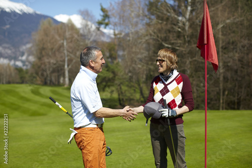 Man and woman at the golf course congratulating