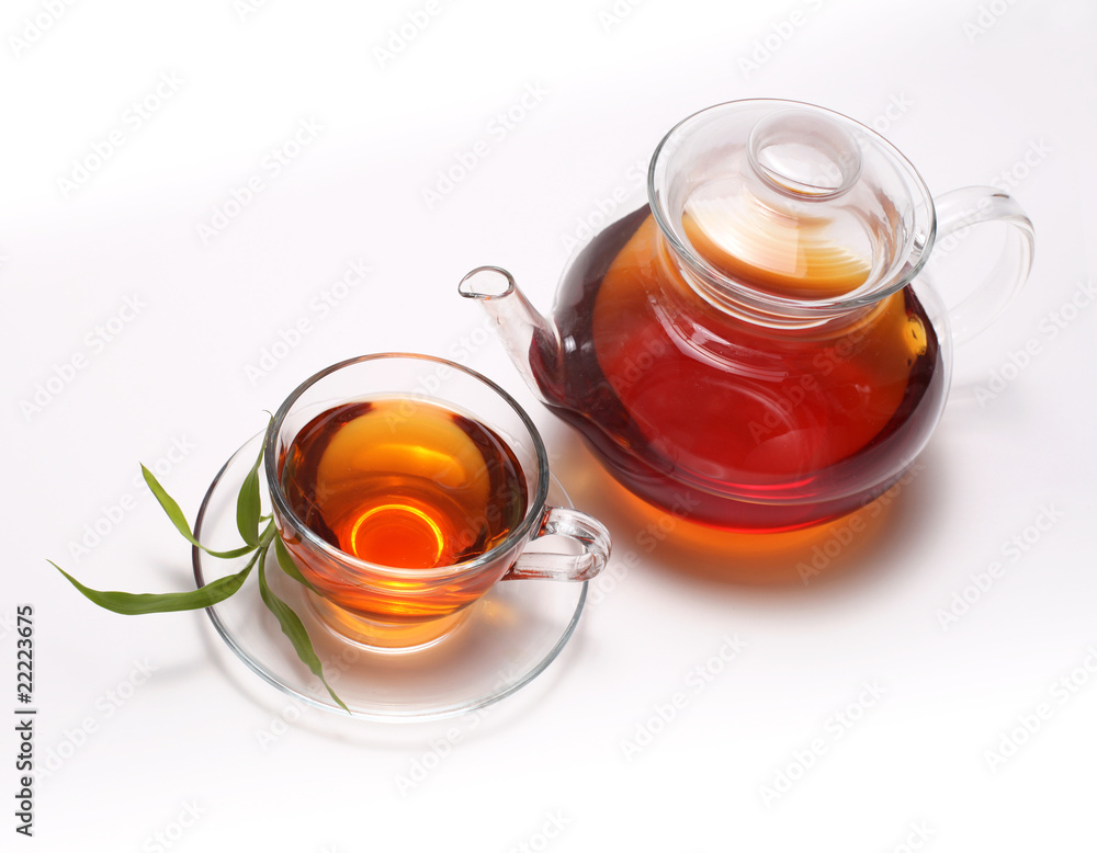 cup with tea and teapot cup with tea and teapot