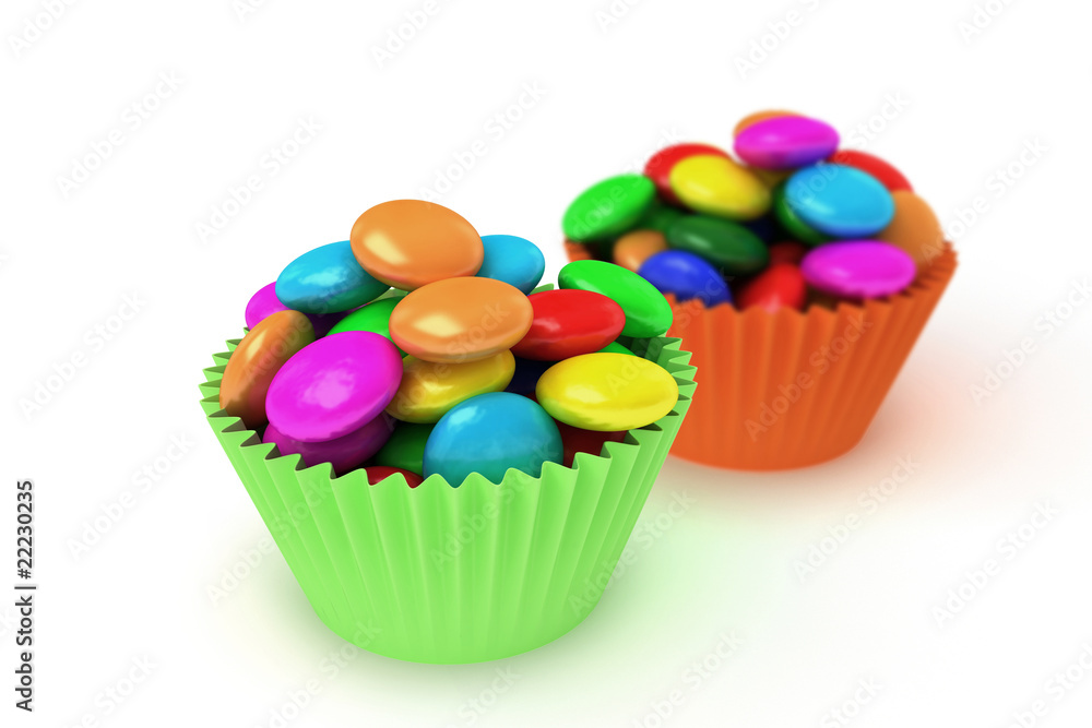 colorful candy in paper cup cake papers isolated over white