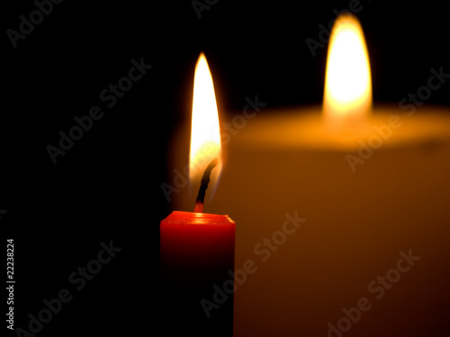 Two candles flaming in the dark