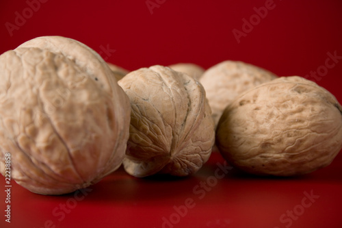 handful of walnuts on a red background