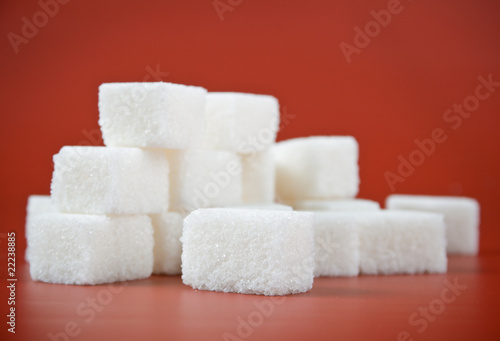 Handful of sugar cube on a red background