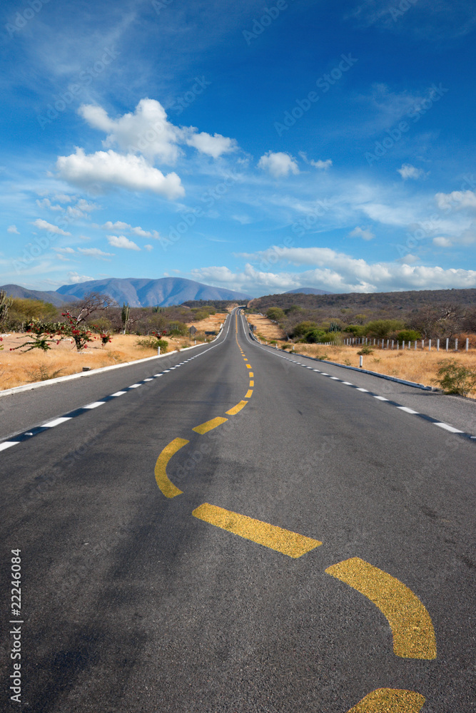 Twisting lane marking on road in desert