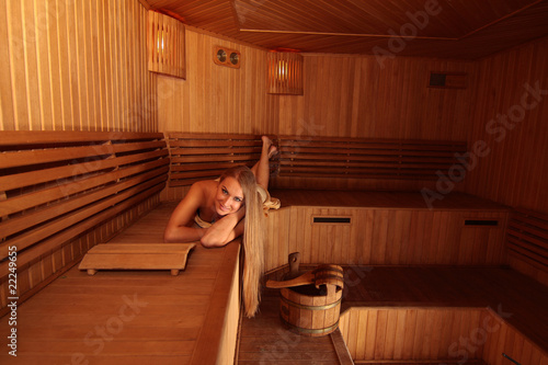 Young attractive blond woman in a steam room