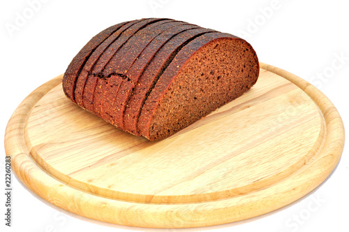 Rye bread on wooden board on white background