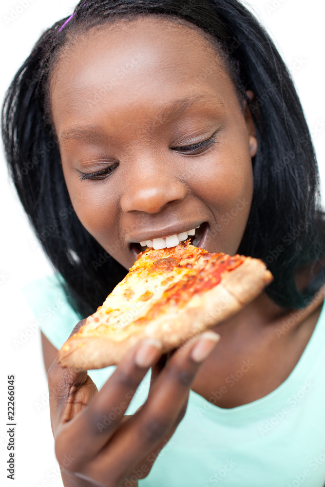 Delighted teen girl eating a pizza