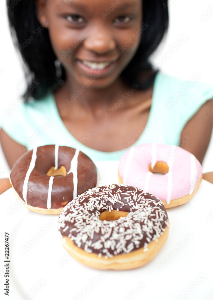 Smiling young woman looking at donuts Smiling young woman looking at donuts