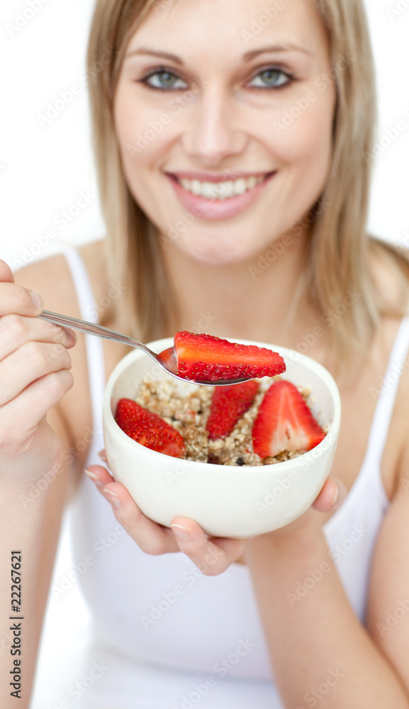 Jolly woman eating cereals with strawberries Jolly woman eating cereals with strawberries