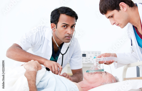 Confident doctors resuscitating a patient