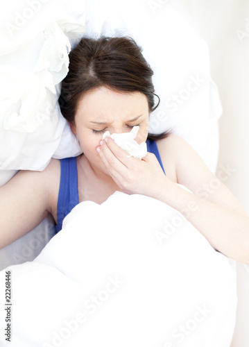 Sick young woman relaxing in her bed