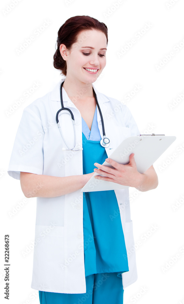 Charming female doctor making notes in a patient's folder Charming female doctor making notes in a patient's folder