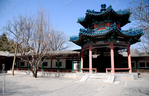 Red chinese pavilion with blue ornate roof © Inna Felker