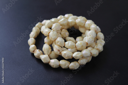 Necklace with yellowish stones on dark background