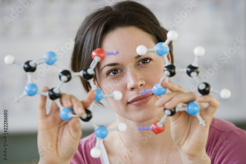 Hispanic woman holding molecular model #22286680