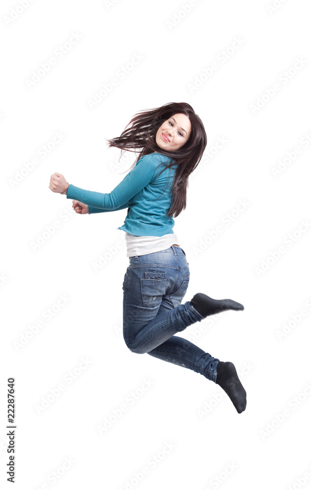 Happy joyful young girl jumping isolated on white