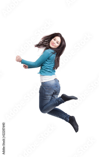 Happy joyful young girl jumping isolated on white