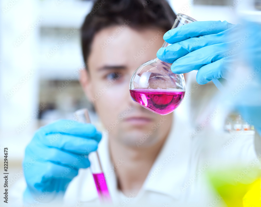© lightpoet - young male researcher carrying out scientific research in a lab © lightpoet - young male researcher carrying out scientific research in a lab