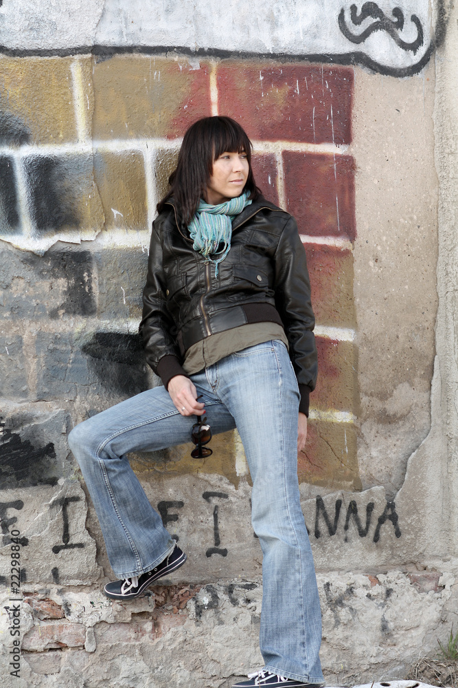 Urban Attitude.Woman against the wall with graffiti. Urban Attitude.Woman against the wall with graffiti.