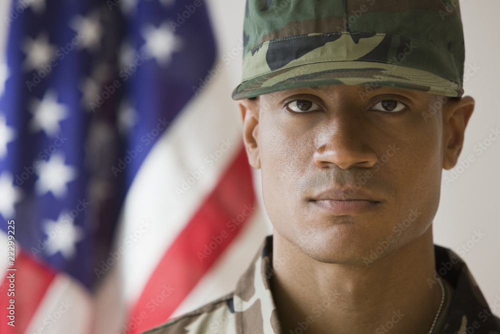 African male soldier in front of American flag African male soldier in front of American flag