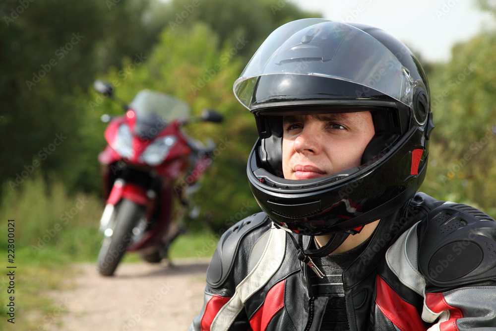 motorcyclist and his bike on country road