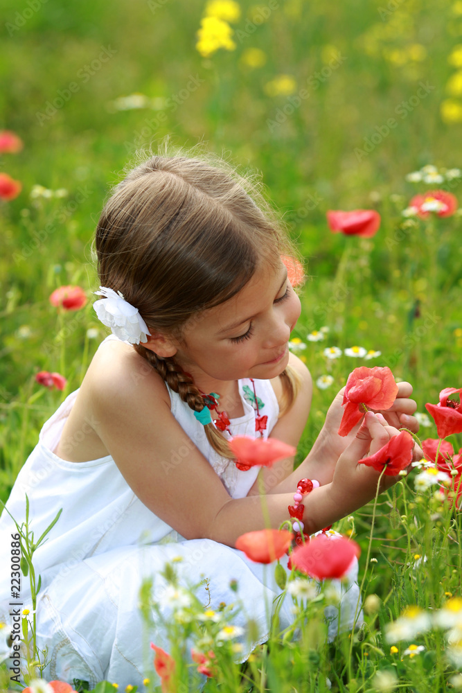 Pretty young girl holding a red poppy Pretty young girl holding a red poppy