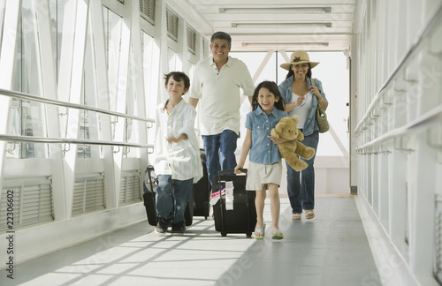 Hispanic family walking through airport photo