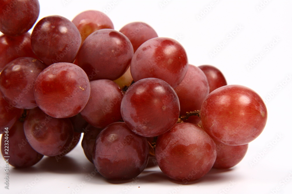 Red grapes in close up on white background Red grapes in close up on white background