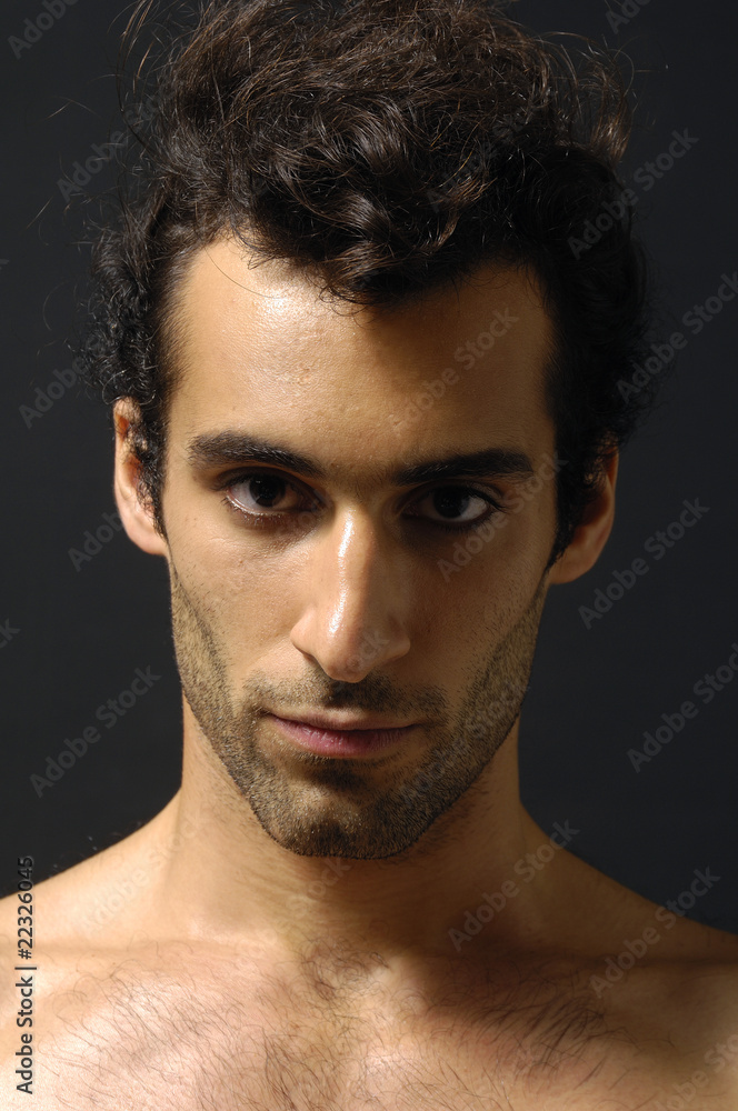 Fototapeta premium portrait of young serious man on black