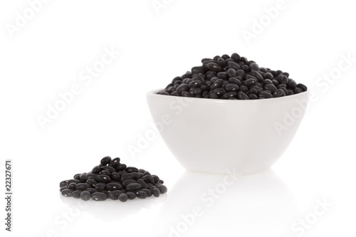 Black turtle beans in a bowl isolated on a white background